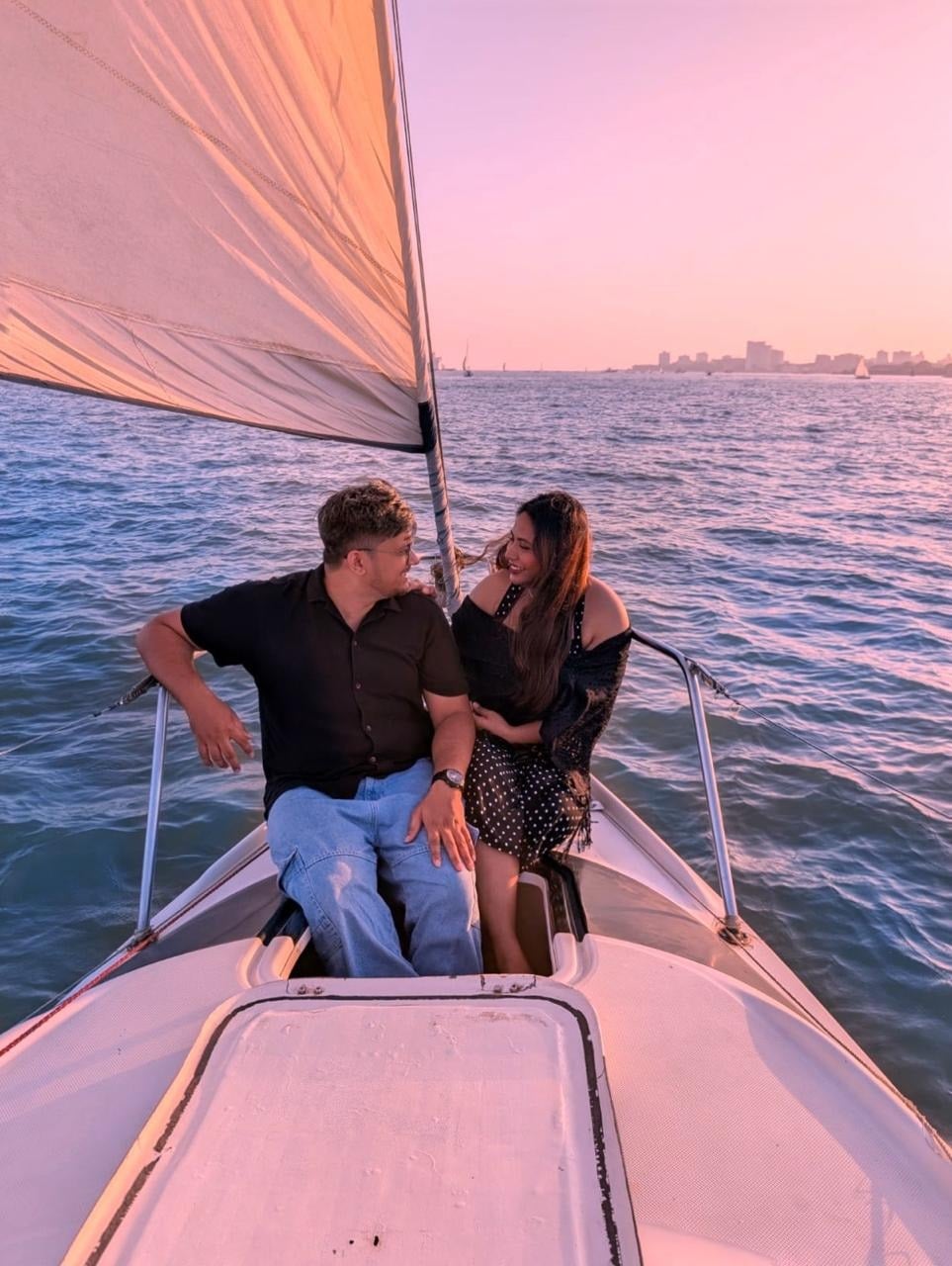 Debadrita and Akshay on a boat at sunset